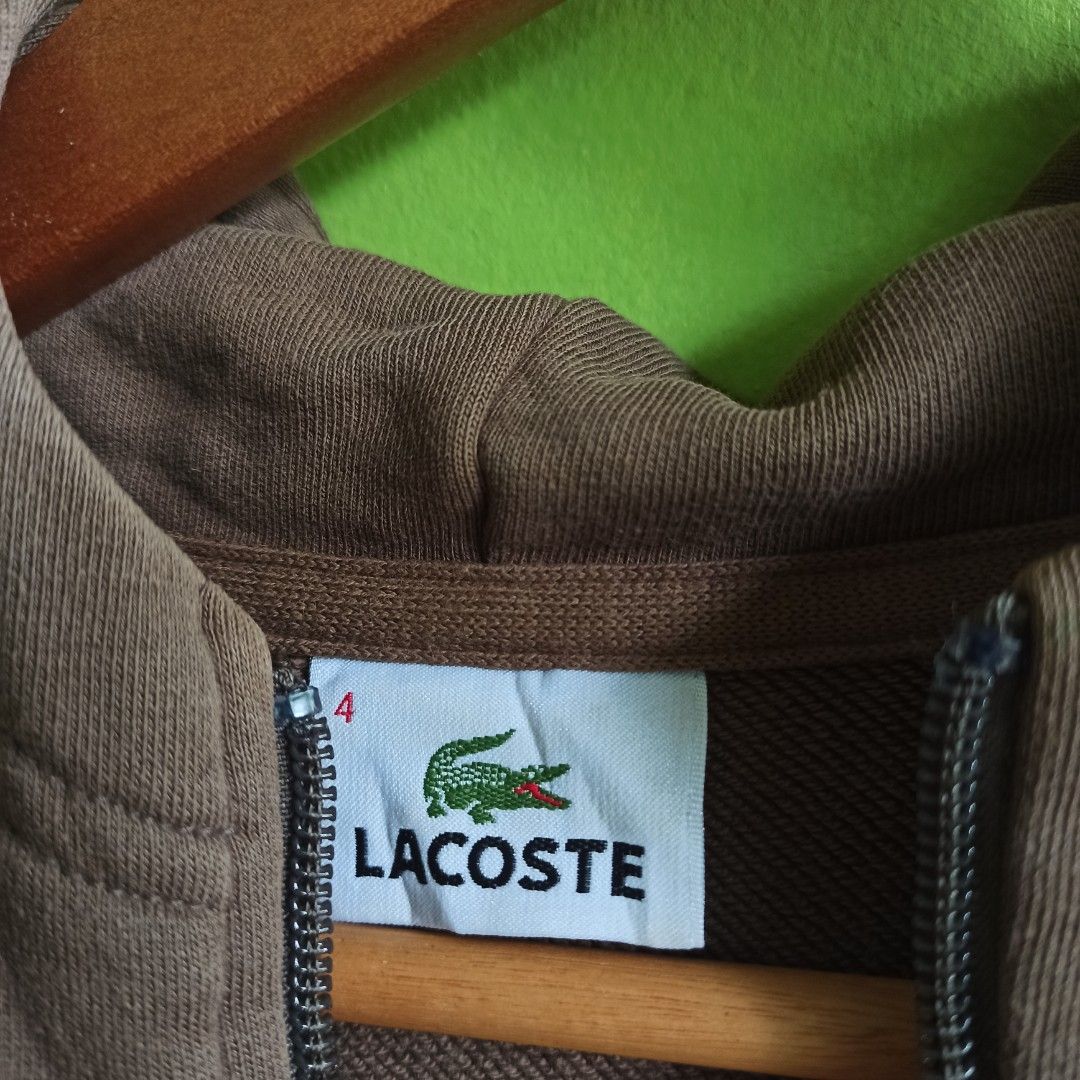 Lacoste Zip-Up Hoodie (Category: Coats, Jackets and Outerwear) located in Tagbilaran City. Submitted by delasierra39181 (Listing ID 1464617496, Image 3). Description: - Brand: Lacoste - Color: Brown - Style: Zip-up Hoodie - Features: Iconic crocodile logo on chest, drawstring hood, front pockets - Size: Tag shows 4 - Ideal for: Casual wear.