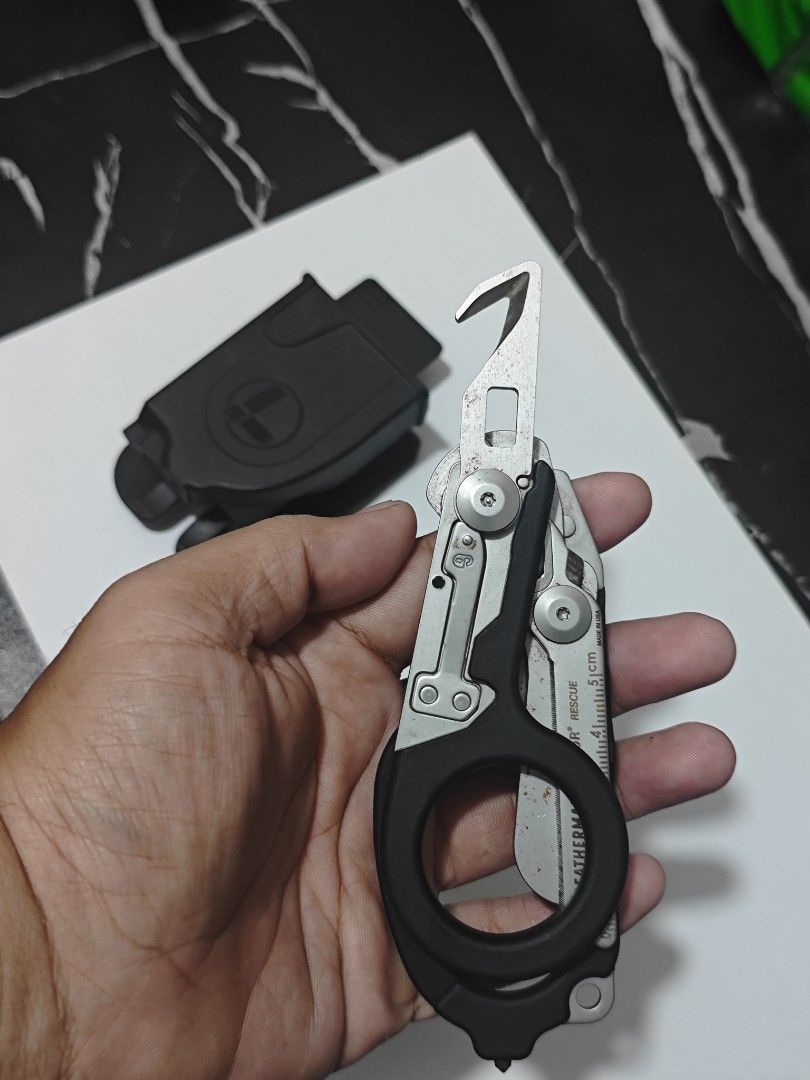 Leatherman Multi-Tool Raptor Rescue Black (Category: Hiking & Camping) located in Quezon City. Submitted by brightfish.7b7f29 (Listing ID 1464575054, Image 3). Description: - Leatherman Raptor Rescue multi-tool in black - Includes protective sheath - Ideal for emergency services, first responders, or everyday carry (EDC) - Fully functional with some signs of cosmetic wear - Features sharp blades and robust, durable construction RFS: Sad to say bu
