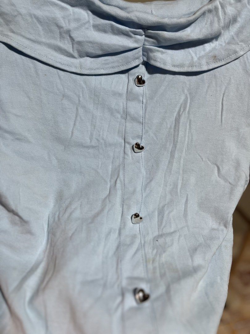 Light Blue Ruffle Collar Button-Up Top (Category: Blouses) located in Caloocan City. Submitted by decluttering.101_ (Listing ID 1464622760, Image 2). Description: - Adorable light blue top - Features a pretty ruffle collar - Full button-down front - Short sleeves - Ideal for casual outfits.