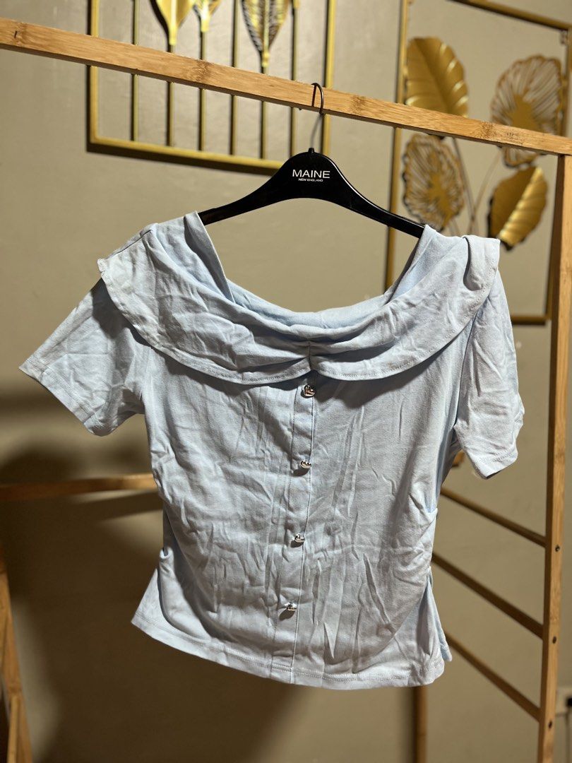 Light Blue Ruffle Collar Button-Up Top (Category: Blouses) located in Caloocan City. Submitted by decluttering.101_ (Listing ID 1464622760, Image 1). Description: - Adorable light blue top - Features a pretty ruffle collar - Full button-down front - Short sleeves - Ideal for casual outfits.