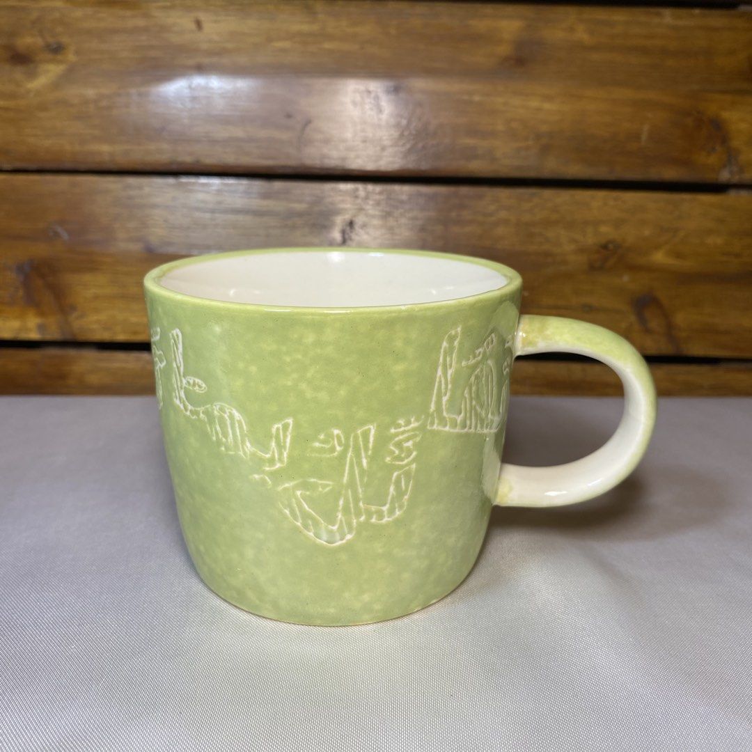 Light Green Textured Mug with Embossed Design (Category: Coffee & Tea Tableware) located in Quezon City. Submitted by oliviararo46032 (Listing ID 1464673403, Image 1). Description: - Adorable light green mug - Unique textured finish with all-around embossed designs - Creamy white interior and handle - Ideal for your morning coffee or tea - Measures approximately 4 inches tall - Perfect single-serving size.
