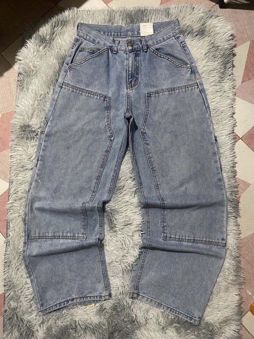 DKNEE CARPENTER BAGGY PANTS (Category: Jeans) located in Mendez-Nunez. Submitted by leighthrift (Listing ID 1464606119, Image 1). Description: WAIST: 30 LENGTH: 40 THIGH: 14 HEM: 10 ISSUE: HEELBITE AND SCRATCHES - Light wash denim jeans - Wide leg fit with carpenter style - Multiple pockets (front and back) - Distressed detailing on the hem - Ideal for casual streetwear - Comfortable and durable.