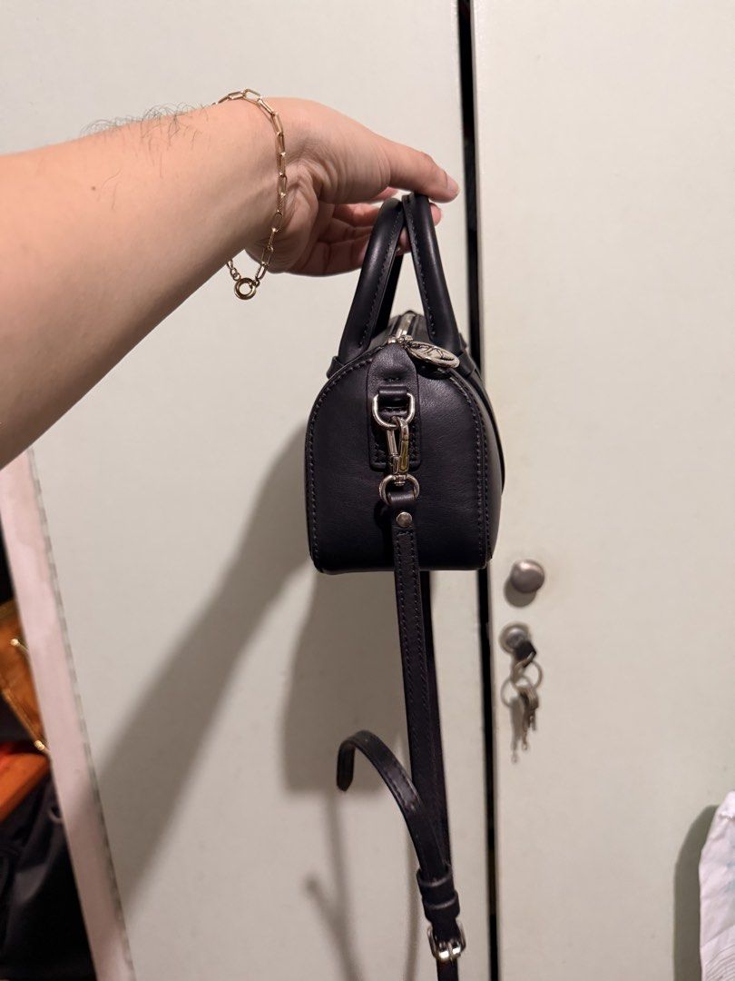 Longchamp Black Leather Crossbody Bag (Category: Luxury Bags & Wallets) located in San Juan City. Submitted by zenrabbit.6105c7 (Listing ID 1464691332, Image 3). Description: - Brand: Longchamp - Material: Premium black leather with silver hardware - Closure: Top zip with round silver pull tab - Straps: Dual top handles + detachable, adjustable shoulder strap - Design: Clean, minimalist style with embossed front logo - Size: Compact and practical