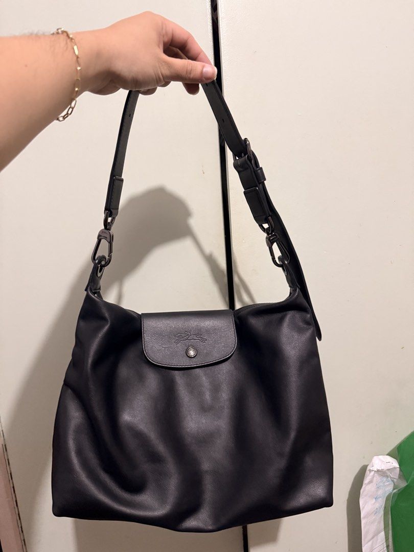 Longchamp Black Leather Shoulder Bag (Category: Luxury Bags & Wallets) located in San Juan City. Submitted by zenrabbit.6105c7 (Listing ID 1464691358, Image 1). Description: - Brand: Longchamp - Color: Classic black - Material: Soft leather with dark metal hardware - Closure: Front flap with snap button and main zip compartment - Strap: Adjustable with side ring attachments - Details: Embossed logo on front flap, clean interior lining - Style: Sl