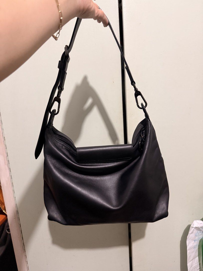 Longchamp Black Leather Shoulder Bag (Category: Luxury Bags & Wallets) located in San Juan City. Submitted by zenrabbit.6105c7 (Listing ID 1464691358, Image 2). Description: - Brand: Longchamp - Color: Classic black - Material: Soft leather with dark metal hardware - Closure: Front flap with snap button and main zip compartment - Strap: Adjustable with side ring attachments - Details: Embossed logo on front flap, clean interior lining - Style: Sl