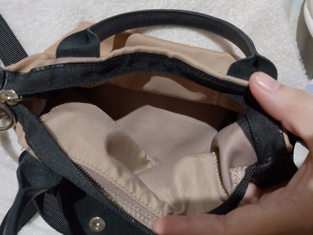 Longchamp Le Pliage Backpack Bag (Category: Backpacks) located in Manila. Submitted by nikkaverda42241 (Listing ID 1464578521, Image 2). Description: - Authentic Longchamp backpack - Color: Beige canvas with black leather trim and straps - Size: Small and compact - Features: Main compartment with zip closure - Condition: Clean inside and out, ready for a new owner - Ideal for: Everyday use or travel.
