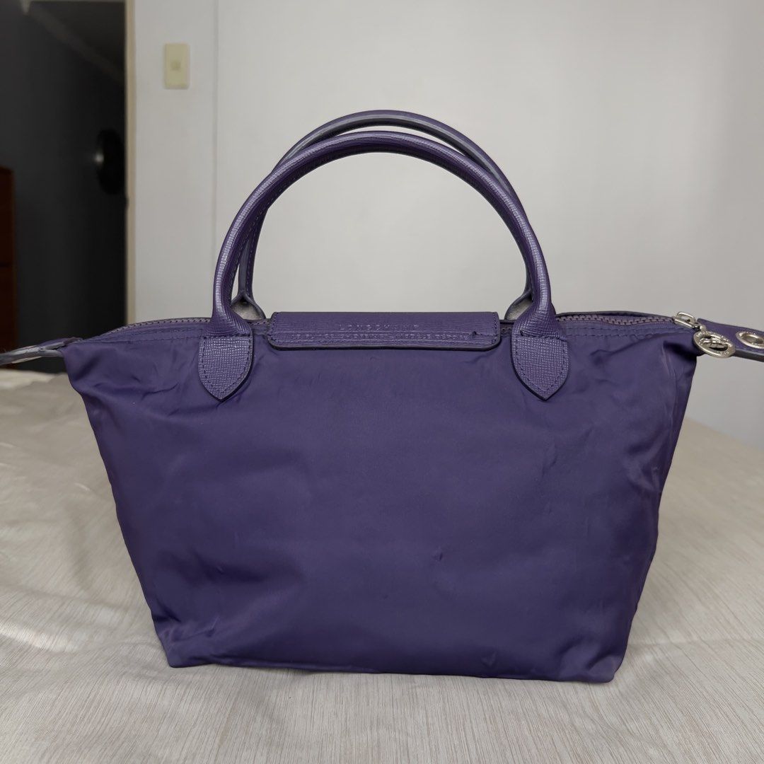 Longchamp Le Pliage Neo Top Handle Bag (Category: Luxury Bags & Wallets) located in Pasig City. Submitted by jenscloset86 (Listing ID 1464675514, Image 2). Description: LONGCHAMP Le Pliage Neo Top Handle Bag Purple Small • Authentic Longchamp Le Pliage Neo Bag • Durable Nylon with Leather Trim • Top Handles, Detachable Shoulder Strap • Minimal signs of usage (wrinkled nylon). Measurement (in inches): Height: 8” Length: 14.5” Bottom length: 9” Bot