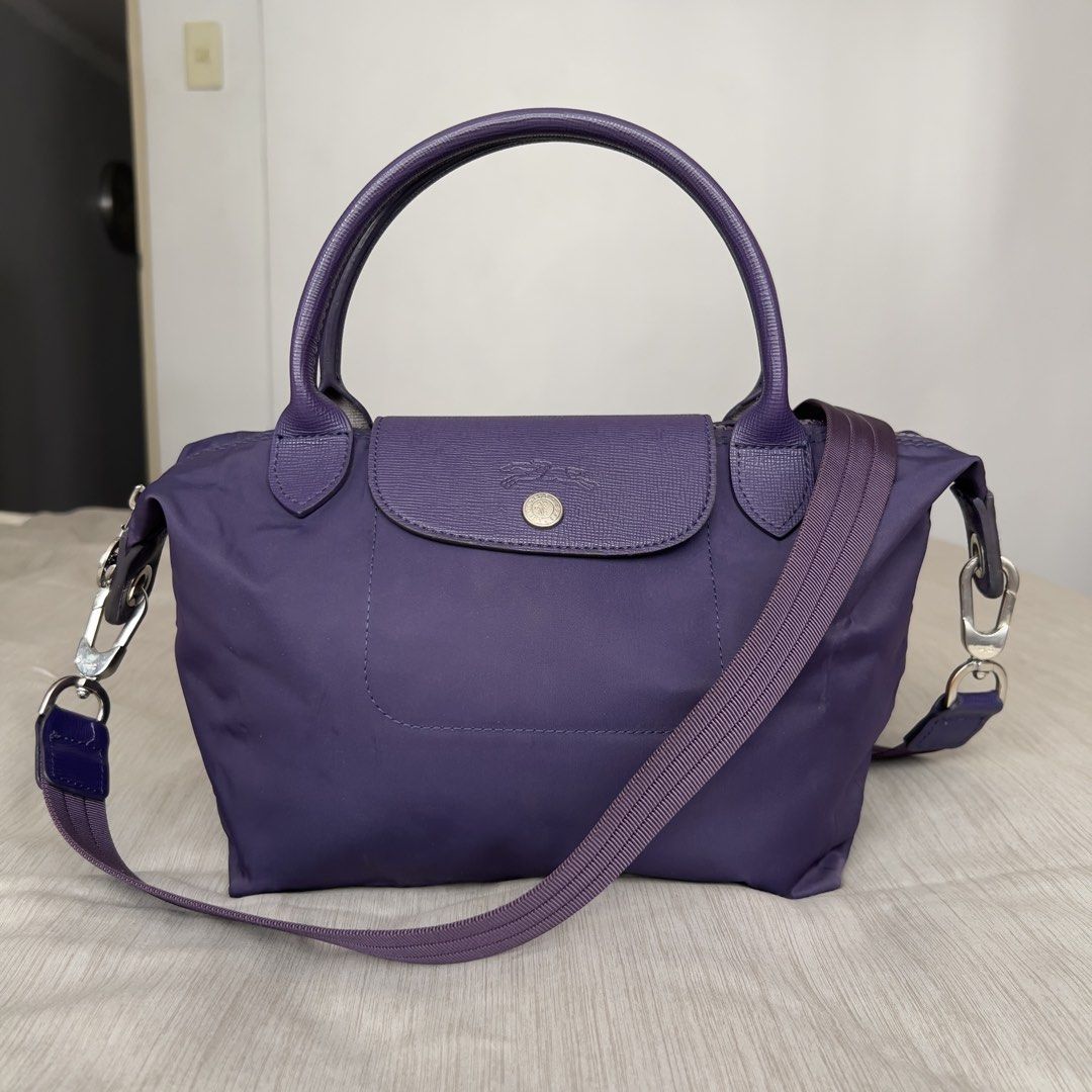Longchamp Le Pliage Neo Top Handle Bag (Category: Luxury Bags & Wallets) located in Pasig City. Submitted by jenscloset86 (Listing ID 1464675514, Image 1). Description: LONGCHAMP Le Pliage Neo Top Handle Bag Purple Small • Authentic Longchamp Le Pliage Neo Bag • Durable Nylon with Leather Trim • Top Handles, Detachable Shoulder Strap • Minimal signs of usage (wrinkled nylon). Measurement (in inches): Height: 8” Length: 14.5” Bottom length: 9” Bot