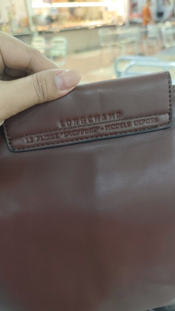 Longchamp Le Pliage Shopping Leather Handbag (Category: Luxury Bags & Wallets) located in Antipolo. Submitted by robannrave98496 (Listing ID 1464640016, Image 2). Description: Longchamp Le Pliage Shopping handbag - Made in France - Rich brown leather - Zipper closure - Interior with branded lining - Includes a cute beaded charm - Ideal for everyday use.