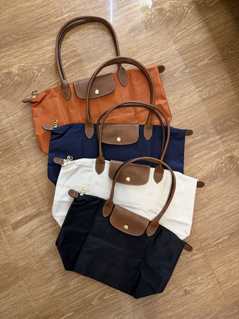 Longchamp Le Pliage Shoulder Bags Multiple Colors (Category: Tote Bags) located in Manila. Submitted by absndy (Listing ID 1464736901, Image 1). Description: For sale: Longchamp Large and Medium Long handle in Brigue, Papier, Noir, and Marine.