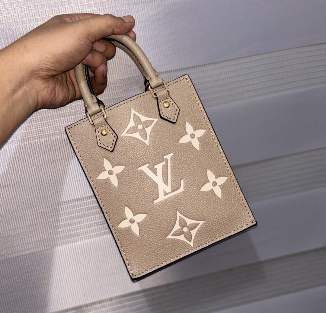 Louis Vuitton beige leather mini tote bag (Category: Luxury Bags & Wallets) located in Bago City. Submitted by christiaaan0515 (Listing ID 1464764965, Image 1). Description: - LV beige grained leather mini tote bag - Dual top handles with black edge glazing and gold-tone hardware - Structured rectangular design with gusseted sides and open top - Soft suede-like interior lining - Features signature LV engraved studs near handle attachments - Clean