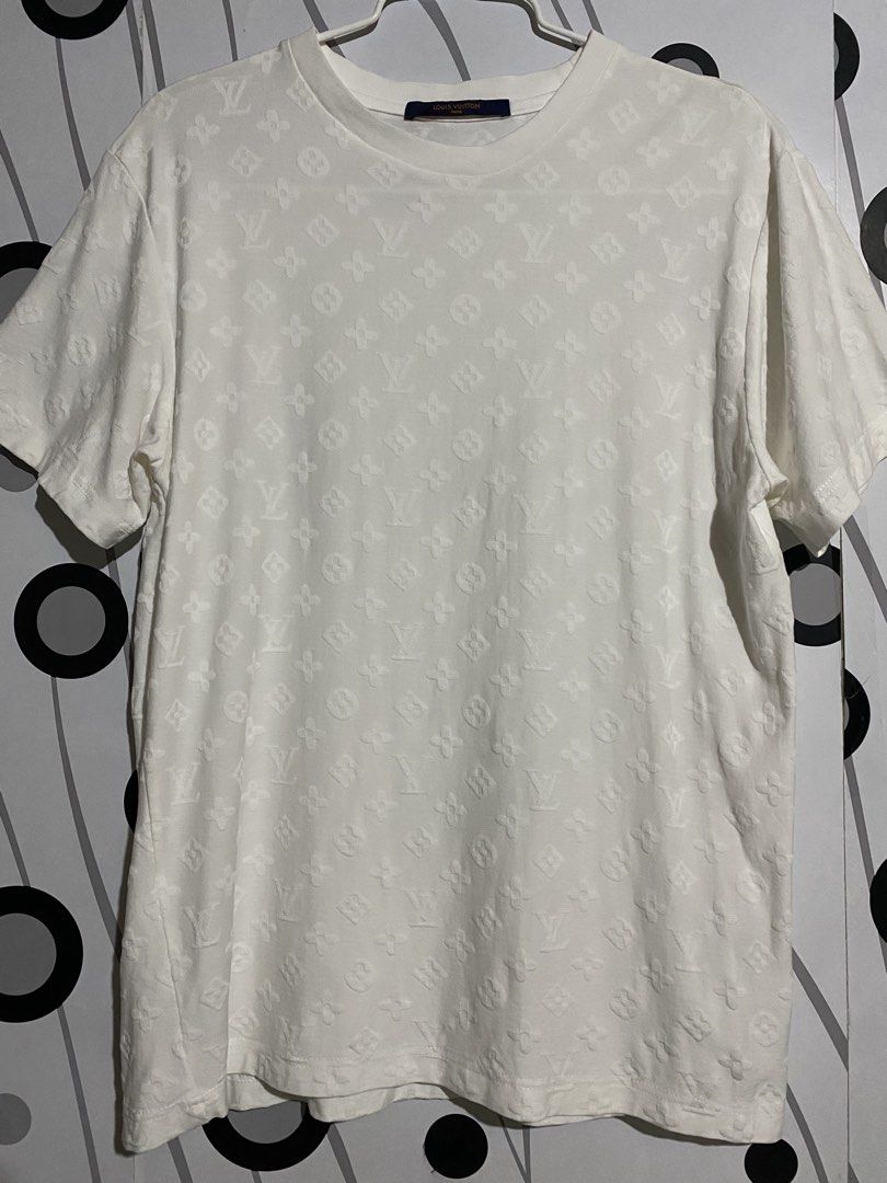 Louis Vuitton Embossed Monogram T-shirt (Category: Tshirts & Polo Shirts ) located in Cebu City. Submitted by patspickph (Listing ID 1464615930, Image 2). Description: This is a white Louis Vuitton Embossed Monogram T-shirt featuring an all-over tonal embossed or hook-and-loop monogram pattern. Dimensions is width 19 and Length 26. Excellent Condition👌.