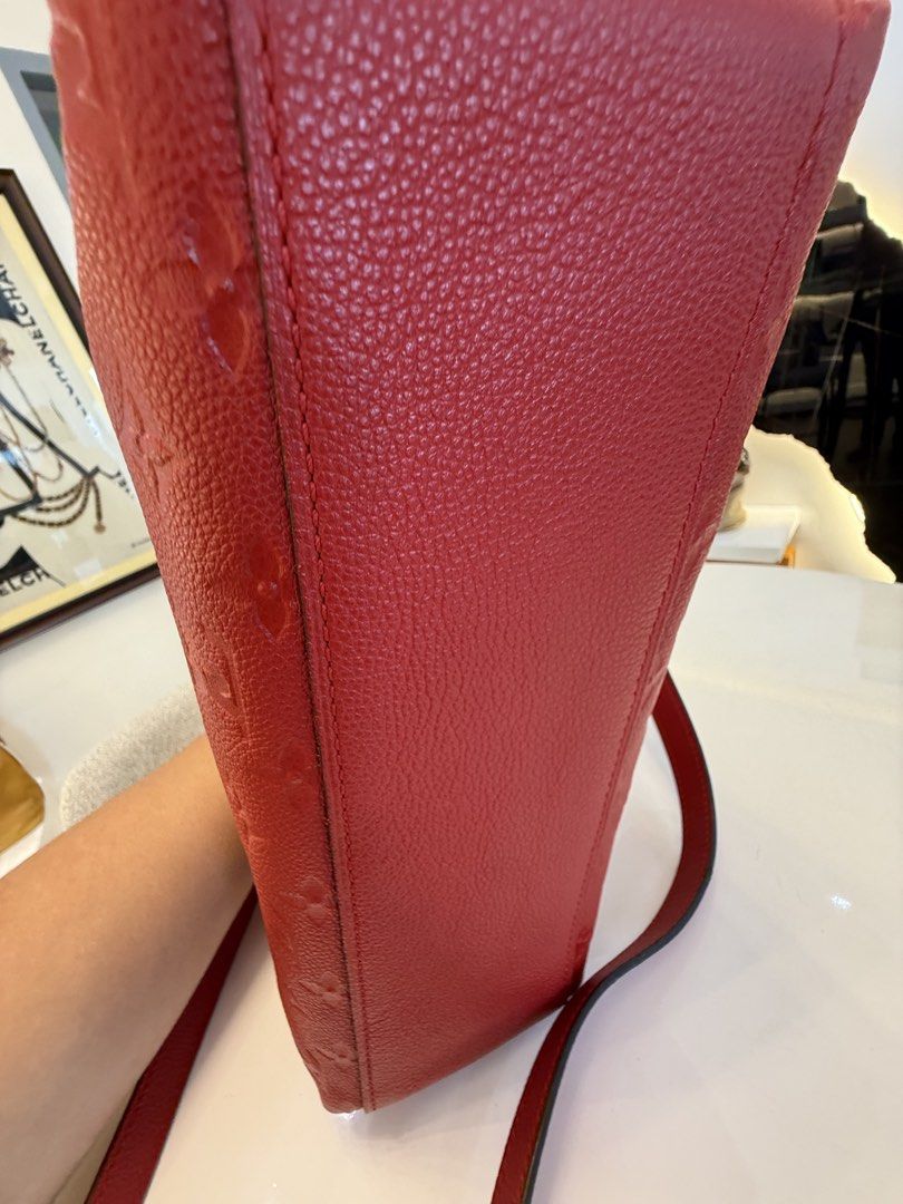 Louis Vuitton Monogram Empreinte Leather Red Shoulder Bag (Category: Luxury Bags & Wallets) located in Alfonso. Submitted by luxurose (Listing ID 1464759202, Image 3). Description: - Authentic Louis Vuitton Monogram Empreinte leather shoulder bag in a stunning bright red - Luxurious gold-tone hardware, zip closures, and strap rings - Soft embossed Monogram pattern throughout - Versatile design featuring top handles and a removable long shoulder s