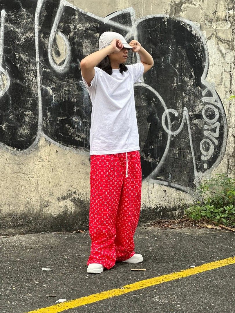 Louis Vuitton Monogram Supreme Collaboration Casual Pants (Category: Joggers) located in Manila. Submitted by lwky.loco (Listing ID 1464753795, Image 1). Description: - Style: Trendy streetwear loose-fit casual pants - Design: All-over monogram pattern with a relaxed wide-leg drape - Comfort: Adjustable drawstring waist featuring sleek metal tips - Colors Available: Red, Blue, White, and Black - Easy Pairing: Looks great with basic t-shirts and y