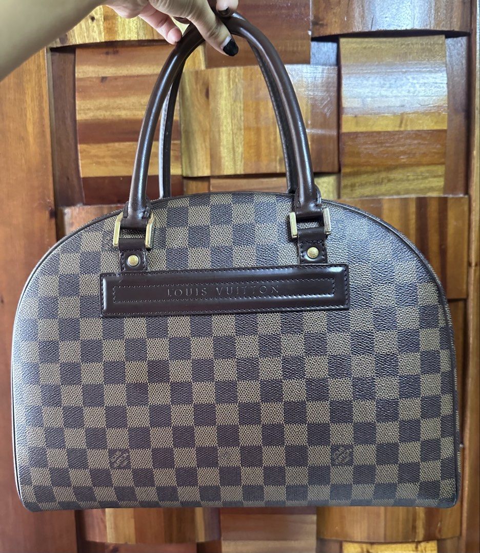 Louis Vuitton NOLITA (Category: Luxury Bags & Wallets) located in General Trias. Submitted by mimispreloves (Listing ID 1464602927, Image 1). Description: - Authentic Louis Vuitton Nolita - Classic Damier Ebene canvas - Iconic checkered pattern - Genuine leather trim and handles - Gold-tone hardware with LV zipper pulls - Spacious interior - Ideal for work and travel - Timeless addition to any collection - minimal signs of wear (hardwares are sti