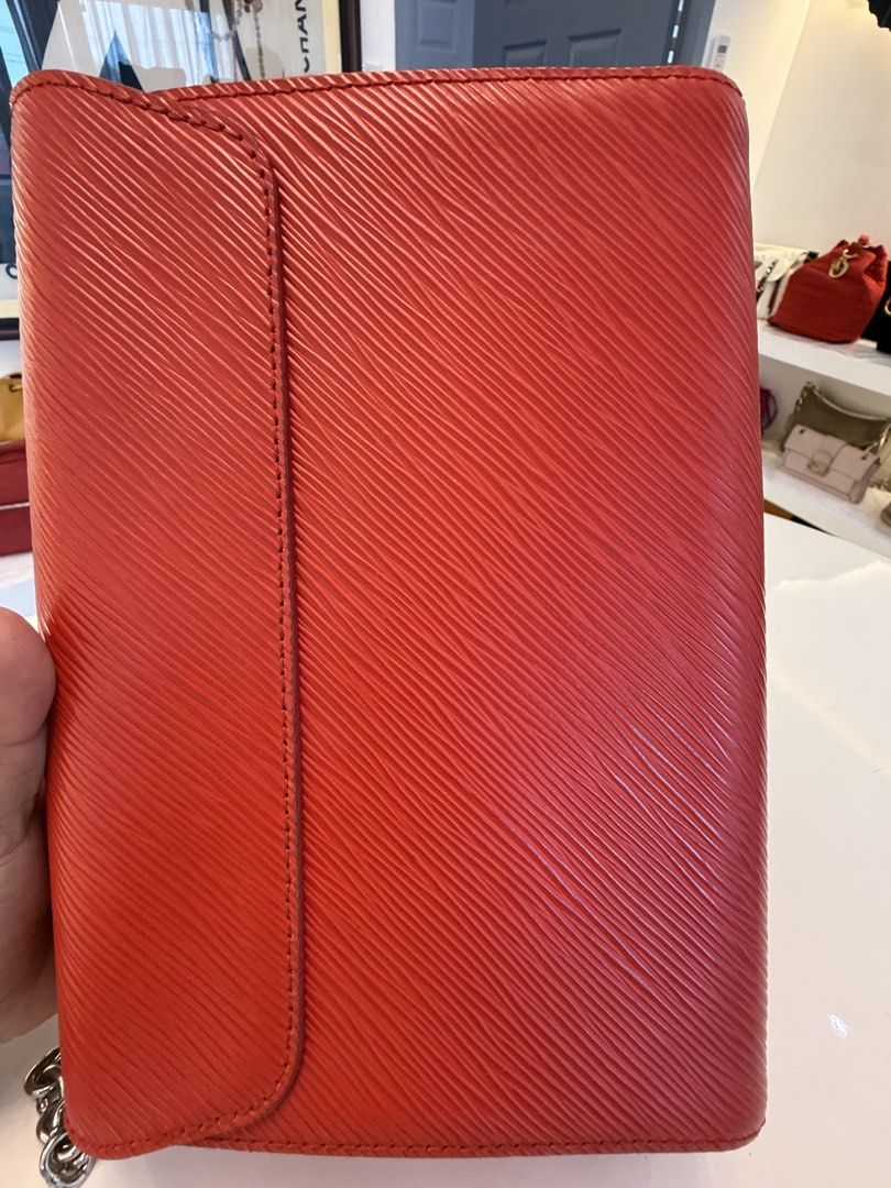Louis Vuitton Twist MM Epi Leather Red (Category: Luxury Bags & Wallets) located in Alfonso. Submitted by luxurose (Listing ID 1464759572, Image 3). Description: - Brand: Louis Vuitton Twist MM - Material: Textured Epi leather in Bright Red - Hardware: Silver with iconic LV twist lock - Interior: Pink suede lining with matching mirror cutout - Strap: Sliding chain strap for shoulder or crossbody wear - Condition: Clean corners, minor hairline scr