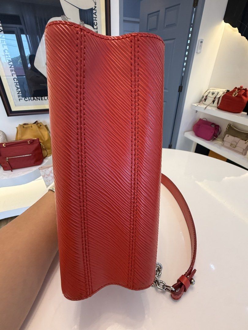 Louis Vuitton Twist MM Epi Leather Red (Category: Luxury Bags & Wallets) located in Alfonso. Submitted by luxurose (Listing ID 1464759572, Image 2). Description: - Brand: Louis Vuitton Twist MM - Material: Textured Epi leather in Bright Red - Hardware: Silver with iconic LV twist lock - Interior: Pink suede lining with matching mirror cutout - Strap: Sliding chain strap for shoulder or crossbody wear - Condition: Clean corners, minor hairline scr