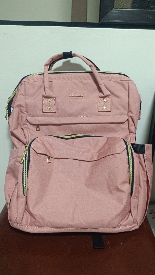 Lovevook Bagpack/laptop baga Pink (Category: Backpacks) located in Taguig. Submitted by Gom.Ez (Listing ID 1464666035, Image 1). Description: - Adorable pink backpack - Features front and side pockets for organization - Adjustable straps for a comfortable fit - Convenient side USB port for on-the-go charging - Ideal for everyday use and travel adventures.