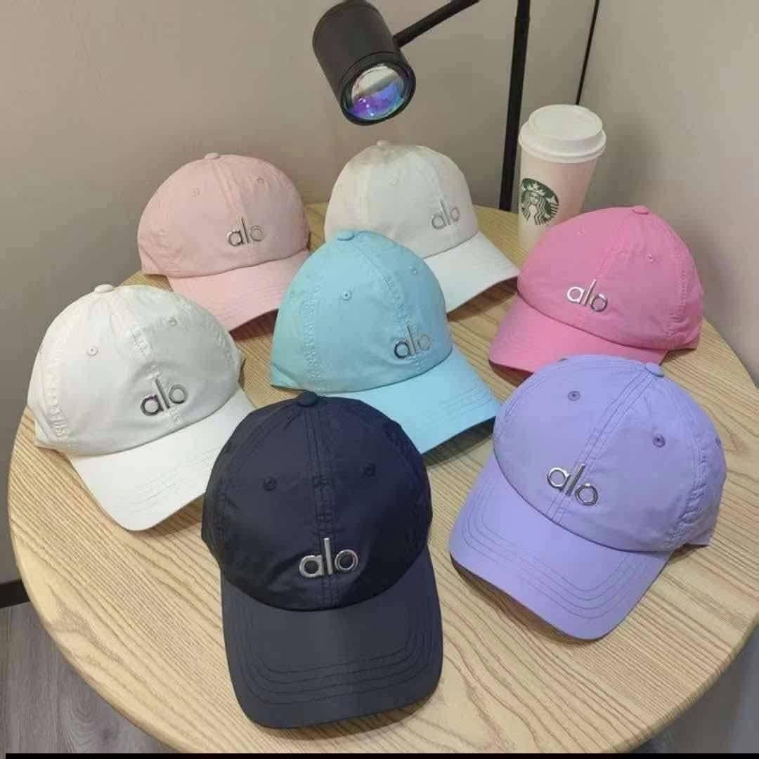 Lululemon, Alo, Prada, On Running Baseball Caps (Category: Caps & Hats) located in Santo Domingo. Submitted by krizzies_korner (Listing ID 1464645374, Image 2). Description: - Variety of baseball caps available - Brands include Lululemon, Alo, Prada, and On Running - Colors: pink, white, black, grey, blue, beige, red, purple, and more - Some caps feature mesh panels - Ideal for everyday wear or sports activities.
