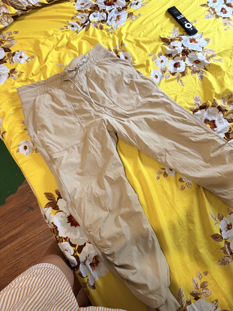 Lululemon Casual Jogger Pants Size 10 Beige (Category: Joggers) located in Malabon City. Submitted by maricris6887078 (Listing ID 1464765739, Image 1). Description: Beige Lululemon jogger pants in size 10. Drawstring waist with ribbed side panels and cuffs. Multiple utility pockets on the front. Body made from nylon and elastane blend. Comfortable fit for daily wear, workouts, or lounging around. Clean condition with clear size and material tags 