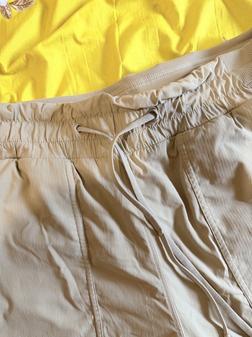 Lululemon Casual Jogger Pants Size 10 Beige (Category: Joggers) located in Malabon City. Submitted by maricris6887078 (Listing ID 1464765739, Image 3). Description: Beige Lululemon jogger pants in size 10. Drawstring waist with ribbed side panels and cuffs. Multiple utility pockets on the front. Body made from nylon and elastane blend. Comfortable fit for daily wear, workouts, or lounging around. Clean condition with clear size and material tags 