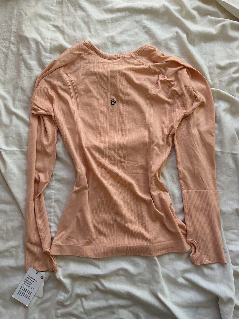 Lululemon Peach Long Sleeve Running Top Size 8 (Category: Longsleeves) located in San Nicolas. Submitted by dijie.cam (Listing ID 1464639561, Image 1). Description: - Brand: Lululemon - Color: Peach - Style: Long sleeve top - Size: 8 - Features: Thumbholes on sleeves, breathable fabric - Material: 100% polyamide - Condition: Brand new with original tags - Ideal for: Runs, workouts, activewear.