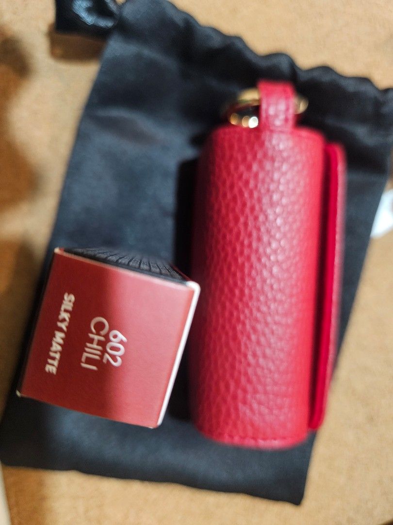 MAC Maximal Silky Matte lipstick with Red Leather Case (Category: Makeup) located in Los Banos. Submitted by acleancloset (Listing ID 1464704772, Image 1). Description: SOLD PER PIECE - Shade available: 602 Chili - Accessories: Bright red pebbled leather lipstick holder with gold hardware and a matching black pouch - Condition: Brand new, unopened, and sealed in original box.