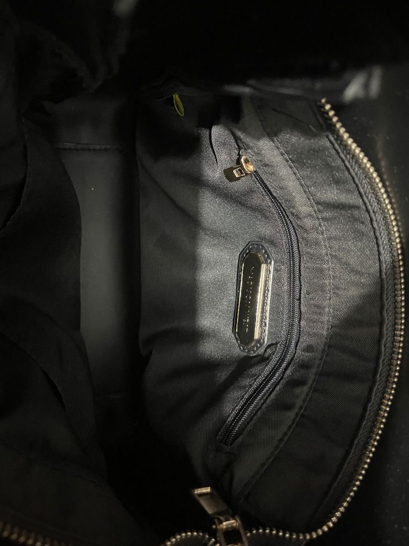 Madison West Shoulder Bag (Category: Shoulder Bags) located in Marikina City. Submitted by bezz_bezzy (Listing ID 1464765113, Image 3). Description: - Color: Black - Material: Smooth faux leather with zero scuffs or scratches - Design: Slouchy yet holds its shape well with a clean minimalist look - Hardware: Distinctive shiny gold piston closure on the front - Strap: Adjustable via side buckle - Condition: Excellent, exterior is flawless.