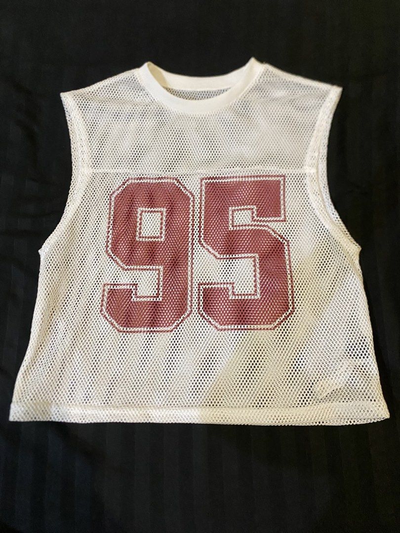 Manfinity White Mesh Tank Top Number 95 Size M (Category: Sleeveless) located in Manila. Submitted by sonder777.329 (Listing ID 1464699951, Image 1). Description: - Brand: Manfinity - Size: Medium - Color/Design: White mesh with large maroon number 95 on front - Fit: Relaxed fit with round neckline - Material: Lightweight polyester mesh - Style: Perfect for streetwear or athletic layering.