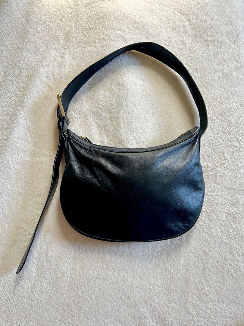 MNG Black Leather Mini Shoulder Bag (Category: Shoulder Bags) located in Carigara. Submitted by abiealberca (Listing ID 1464576286, Image 1). Description: - Brand: Mango (MNG) - Material: Black Genuine Leather (Lamb Skin) - Design: Curved silhouette, classic and simple, adjustable gold buckle - Features: Adjustable shoulder strap with gold buckle, zipper closure - Interior: Lined - Flaws: Minimal sign of usage, tag removed - Use: Great for everyd