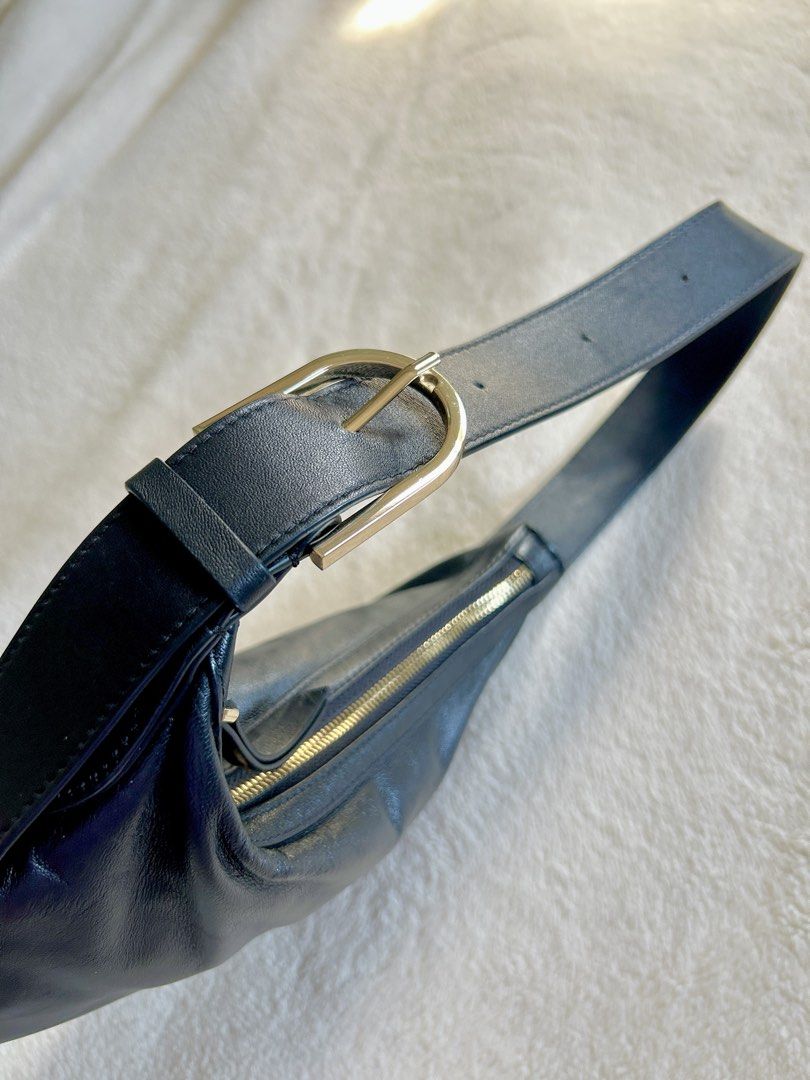 MNG Black Leather Mini Shoulder Bag (Category: Shoulder Bags) located in Carigara. Submitted by abiealberca (Listing ID 1464576286, Image 3). Description: - Brand: Mango (MNG) - Material: Black Genuine Leather (Lamb Skin) - Design: Curved silhouette, classic and simple, adjustable gold buckle - Features: Adjustable shoulder strap with gold buckle, zipper closure - Interior: Lined - Flaws: Minimal sign of usage, tag removed - Use: Great for everyd