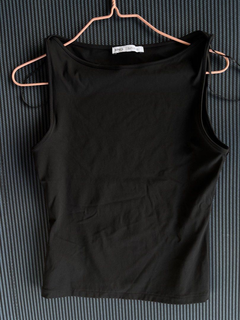 Mango Black Sleeveless Tank Top (Category: Sleeveless) located in Baguio. Submitted by pinkynj (Listing ID 1464654527, Image 3). Description: - Basic black tank top from Mango - Sleeveless with a classic boat neckline - Features a tie-back detail - Perfect for versatile styling, wear it alone or layer it up - Made in Cambodia - Once used only - Original price: almost 2k.