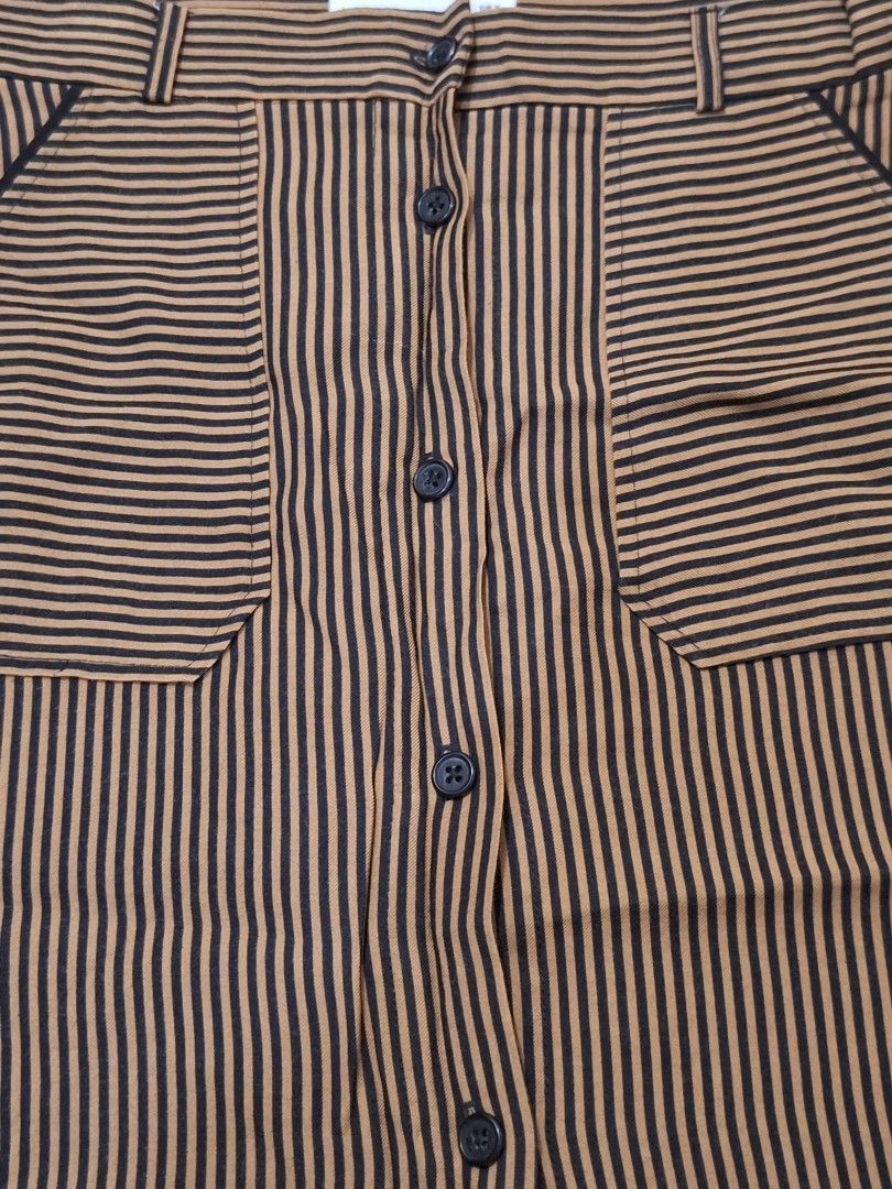 MANGO Brown and Black Striped Button-Front Skirt with Pockets (Category: Skirts) located in Makati City. Submitted by worn2work_treasures (Listing ID 1464612436, Image 2). Description: - Cute brown and black striped skirt - Full button-front closure - Two functional front pockets - Belt loops on waistband - Perfect for casual wear and easy to style -A-line Size Length from waist - 18 inches/ 46 cm Hip Width - 19 .5 inches Compostion: 92% Viscose 