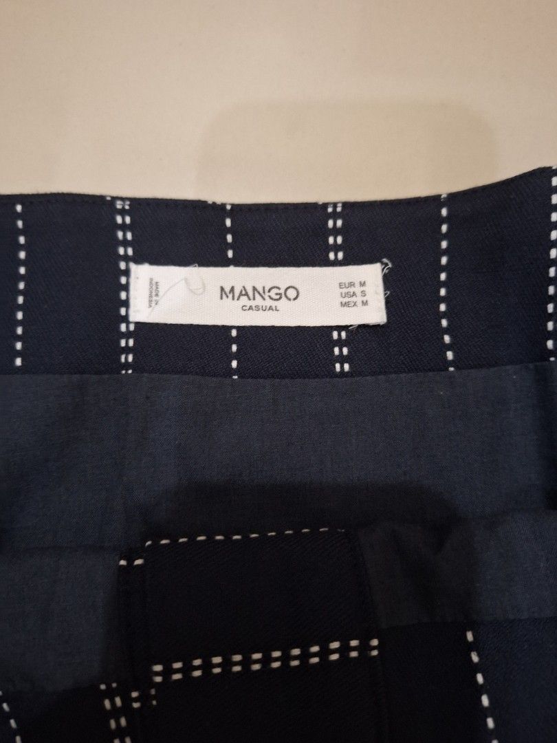 Mango Casual Striped Button-Front Mini Skirt Size M (Category: Skirts) located in Makati City. Submitted by worn2work_treasures (Listing ID 1464629120, Image 3). Description: - Navy blue mini skirt - White pinstripe detail - Button-front design - Brand: Mango Casual - Made in Indonesia - Size: Medium (EUR M, MEX M) - Ideal for everyday wear -Size: waist: 15 inches hips: 19.75 inches length from waist : 17 inches Composition : 65;Polyester, 35% va