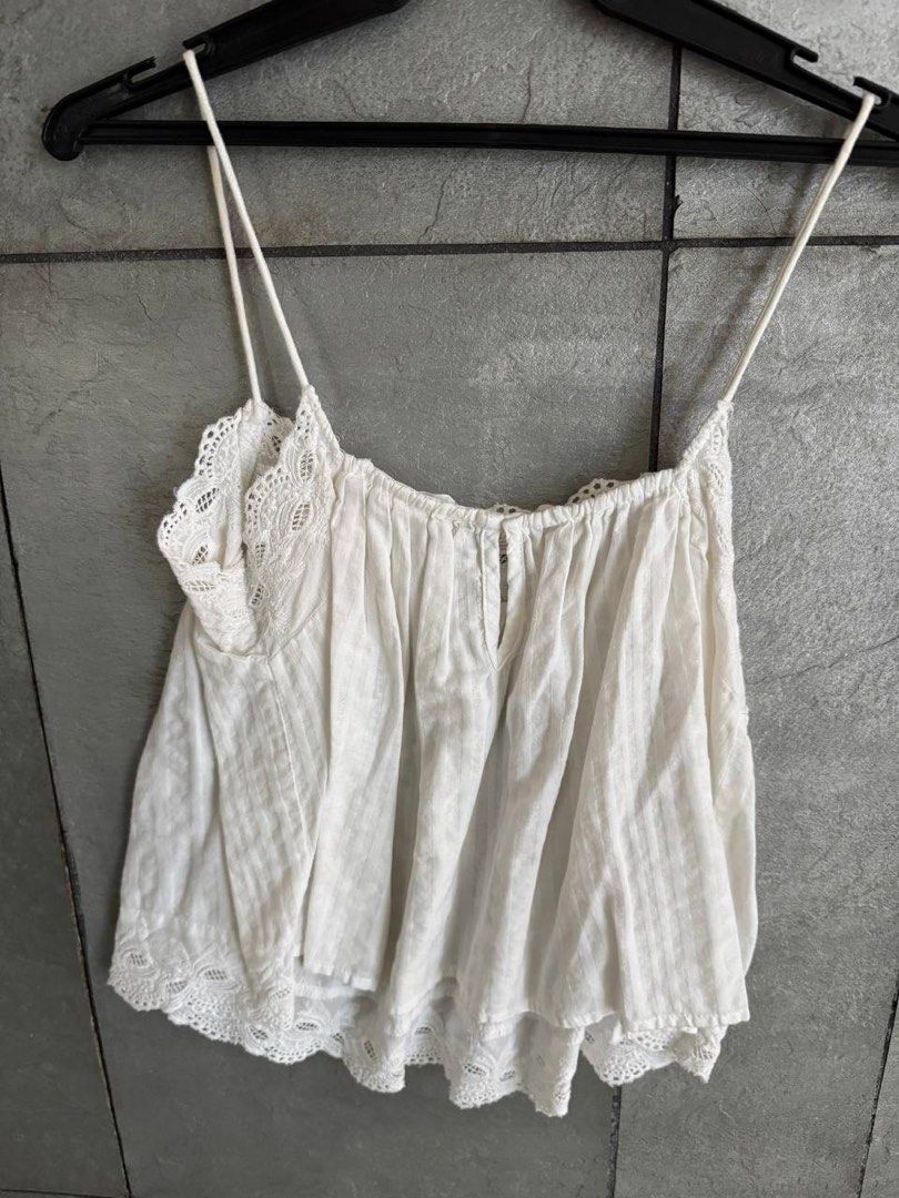 Mango Casual White Lace Trim Cami Top Size S (Category: Sleeveless) located in Taguig. Submitted by anxmz (Listing ID 1464676202, Image 3). Description: - White cami top from Mango - Features delicate lace trim on neckline and hem - Thin, adjustable straps - Gathered bust detail with a small button - Lightweight fabric with subtle vertical stripes - Perfect for layering or wearing solo.