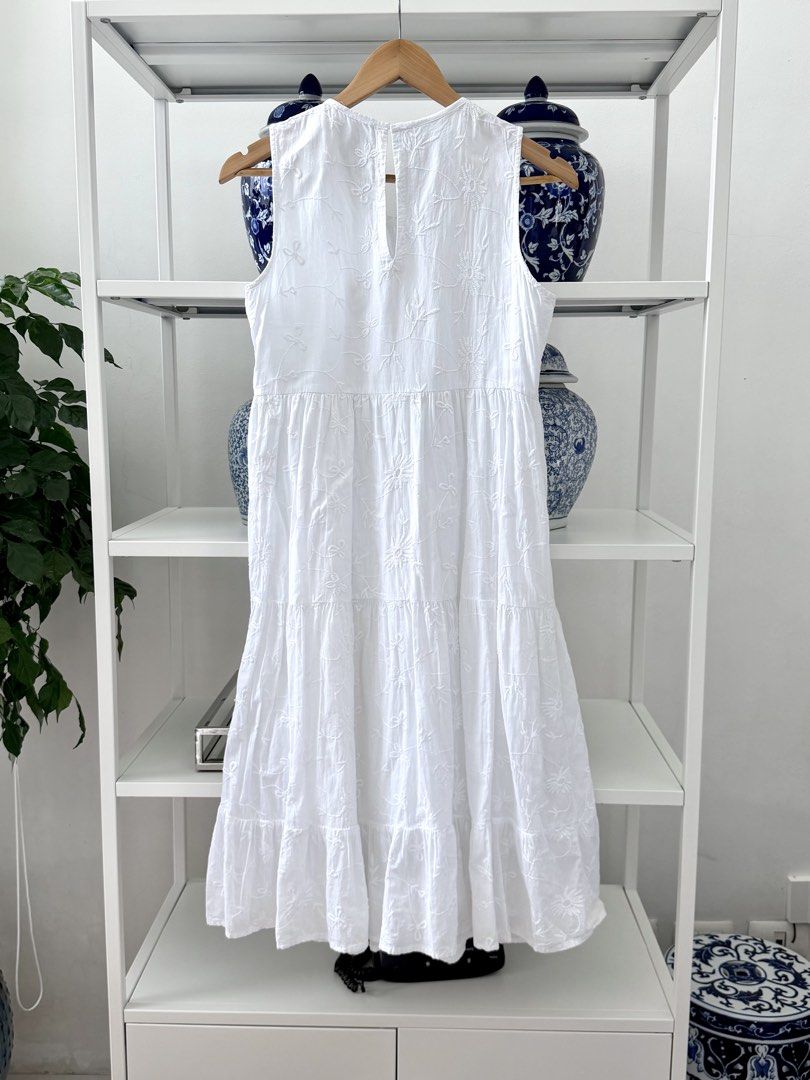 Mango White Embroidered Tiered Midi Dress (Category: Dresses) located in Lipa City. Submitted by pauline0303 (Listing ID 1464658313, Image 3). Description: - White midi dress from Mango - Sleeveless design - Tiered, flowy skirt - All-over delicate floral embroidery - Keyhole opening at the back with button closure - Ideal for casual outings or beach days - Comfortable and light fabric.