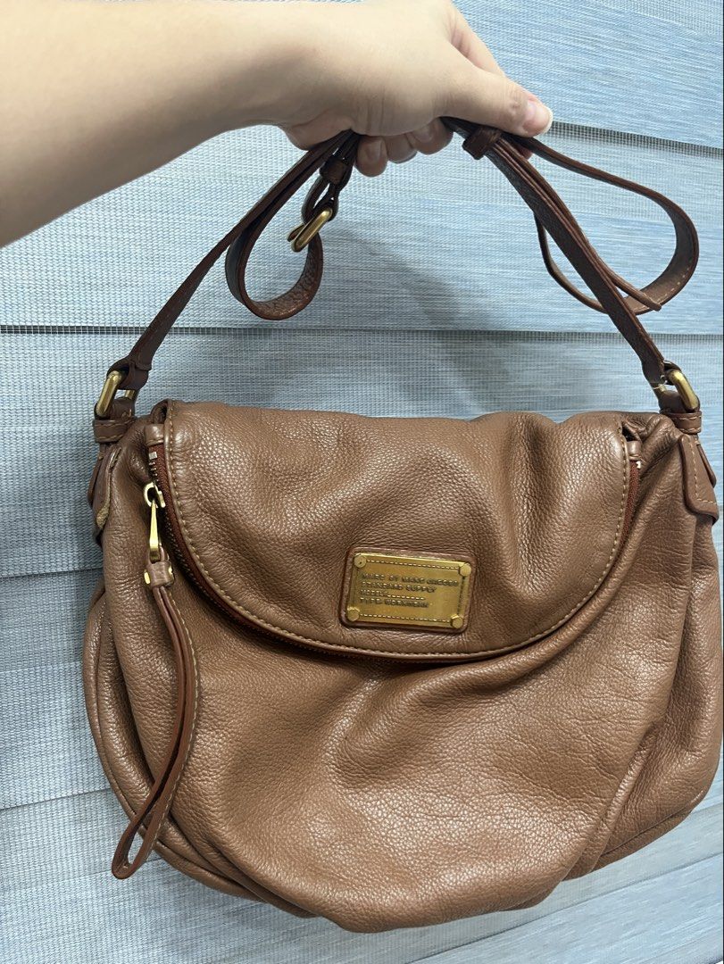 Marc by Marc Jacobs Shoulder Bag (Category: Luxury Bags & Wallets) located in Bulacan. Submitted by spring_cleaning_ (Listing ID 1431073200, Image 1). Description: - Brand: Marc by Marc Jacobs - Color: Brown - Closure: Flap with gold-tone metal plate - Interior: Lined with black and white logo print fabric - Strap: Adjustable shoulder strap - Origin: Made in Indonesia.