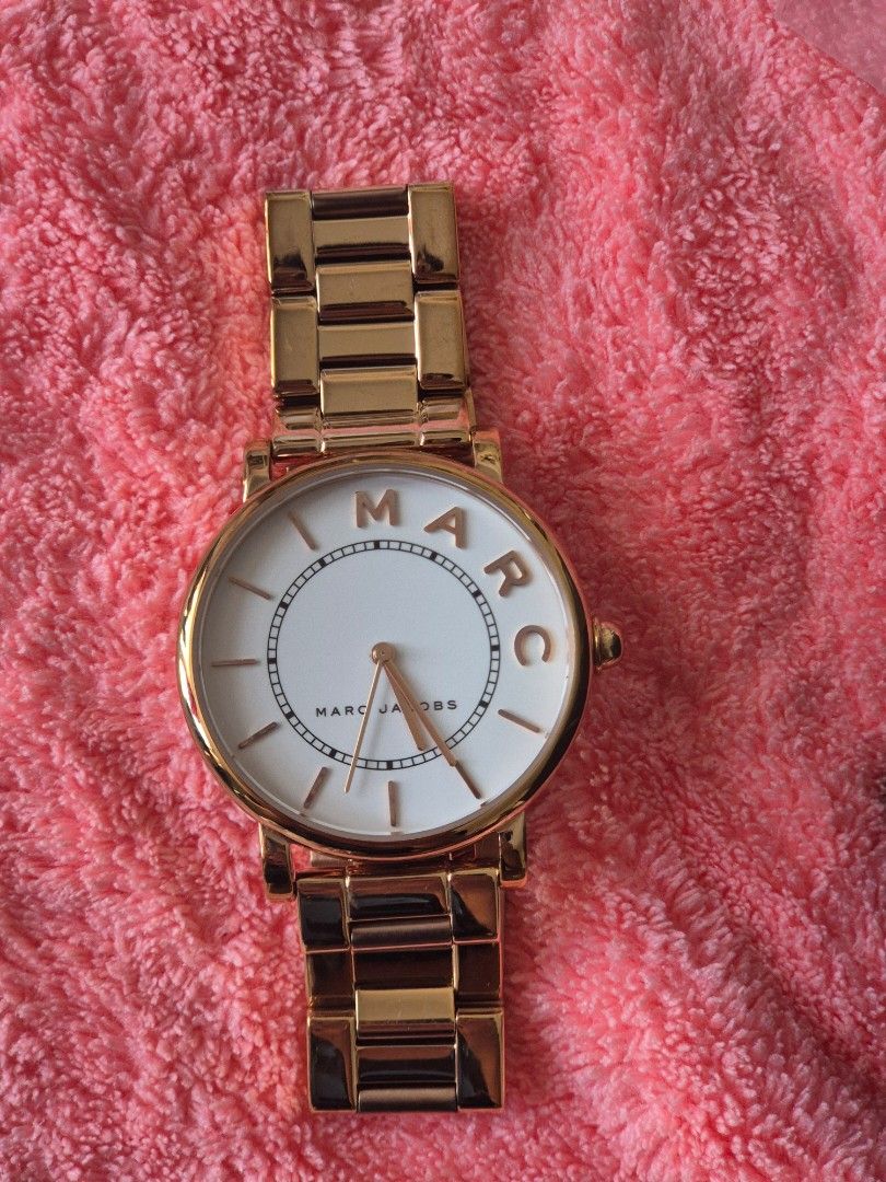 Marc Jacobs Gold White Dial Watch (Category: Women's Watches) located in Manila. Submitted by devrizdmtm04292 (Listing ID 1464596317, Image 1). Description: - Elegant gold watch with a classic white dial. - Features 'MARC' branding on the watch face. with box - Comes with extra links for a customized fit. - Includes the original box and instruction manual. - Ideal for everyday wear..