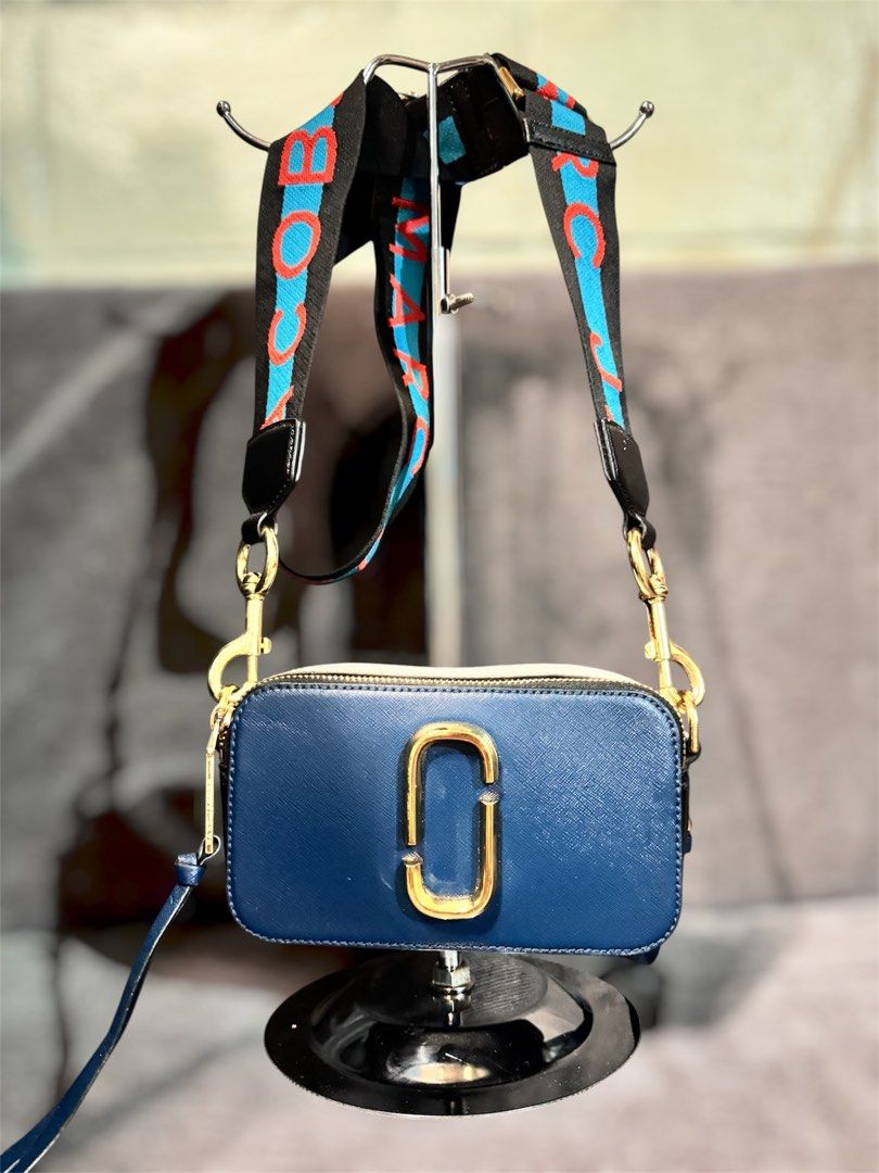 Marc Jacobs Snapshot Camera Bag Blue Gold Strap (Category: Luxury Bags & Wallets) located in Manila. Submitted by dearpinkcollections (Listing ID 1464677115, Image 1). Description: - Authentic Blue Marc Jacobs Snapshot bag - Iconic gold double J logo - Comes with a colorful strap - Convenient back pocket for quick access - Elegant gold hardware/ Navy Blue - Secure zipper closure - Ample interior space for your essentials.