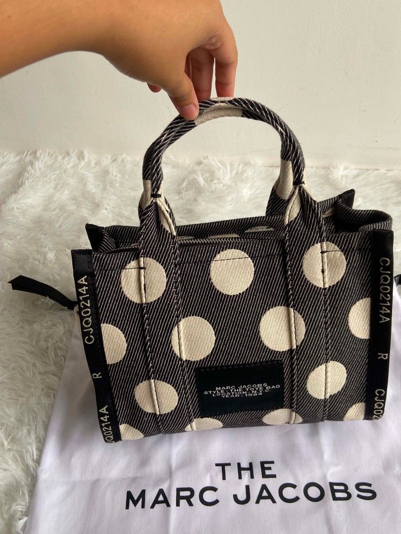 Marc Jacobs The Tote Bag Polka Dot Mini (Category: Tote Bags) located in Bulacan. Submitted by bella.ken.varietystore (Listing ID 1464663329, Image 3). Description: Cute Marc Jacobs mini tote bag. Features a black and white polka dot pattern. Has top handles and a detachable shoulder strap. Comes with the dust bag. Great for everyday use..