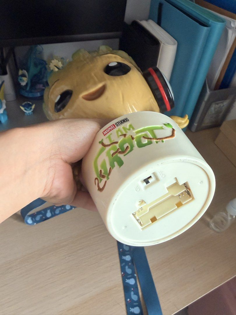 Marvel Studios I Am Groot popcorn bucket (Category: Western Merchandise) located in Manila. Submitted by ellede32655 (Listing ID 1464618948, Image 3). Description: - Adorable Groot design with headphones. - Opens to reveal storage space inside. - Base reads 'Marvel Studios I Am Groot'. - Comes with a blue lanyard. - Ideal for collecting or storing small treasures. - Batteries are not included..