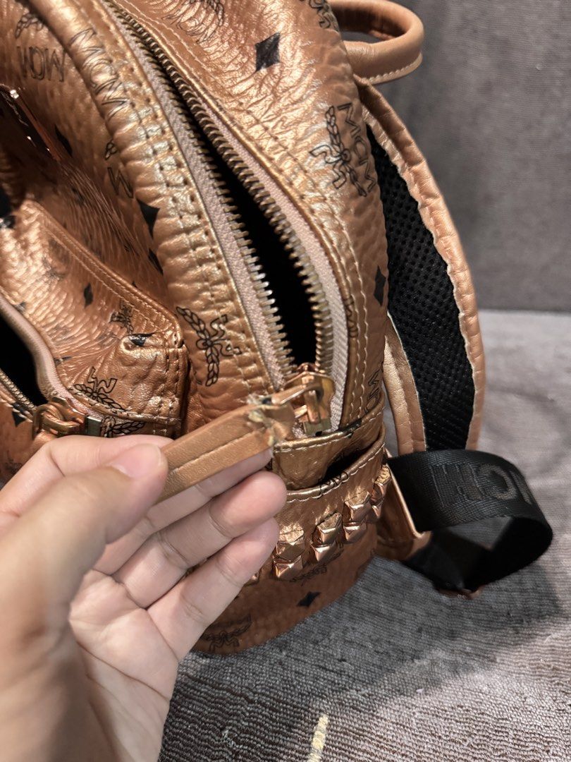 MCM Rose Gold Monogram Mini Backpack (Category: Luxury Bags & Wallets) located in Manila. Submitted by dearpinkcollections (Listing ID 1464676252, Image 3). Description: - MCM mini backpack in a chic rose gold metallic finish. - Features the signature all-over MCM monogram print. - Secure zip closure for the main compartment. - Convenient front zip pocket for essentials. - Adjustable shoulder straps for a comfortable fit. -slightly used.