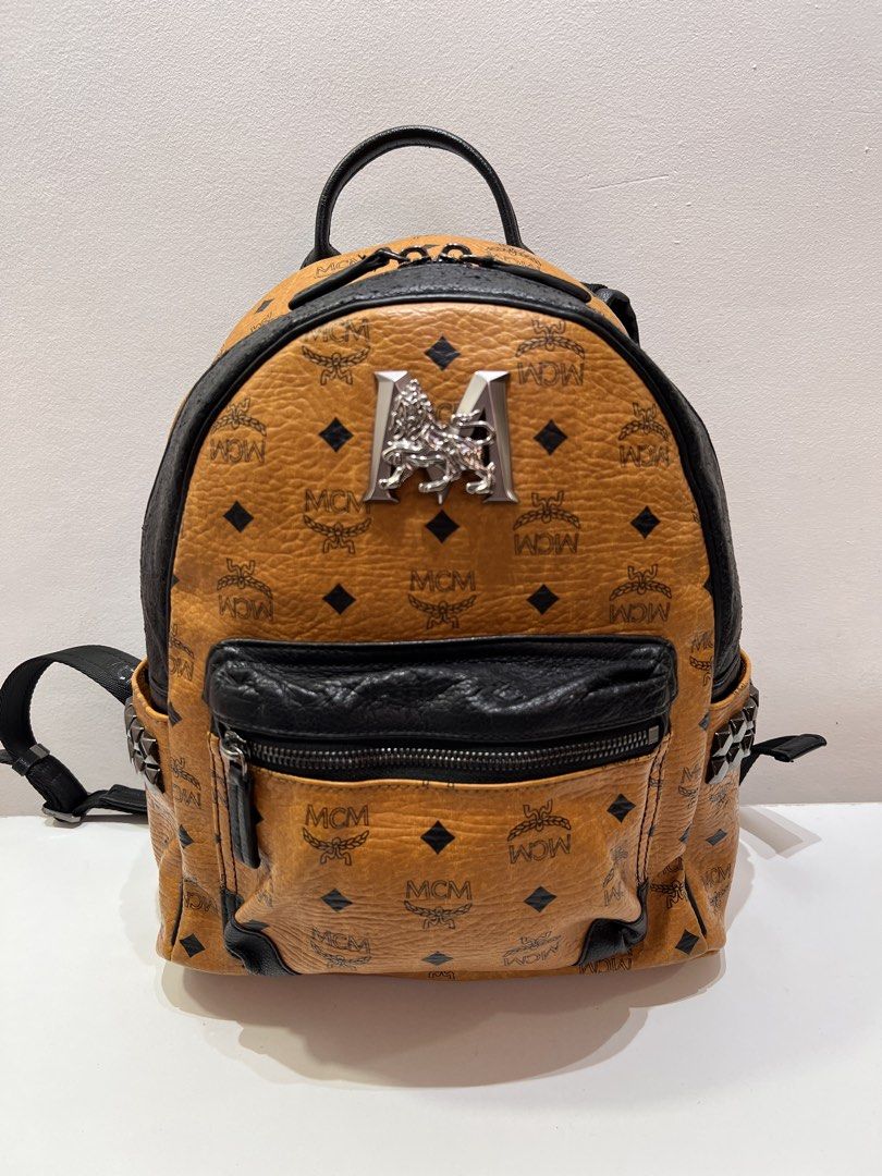 MCM Visetos Stark Cognac Small Backpack (Category: Luxury Bags & Wallets) located in Cebu City. Submitted by brandedcorner_ph (Listing ID 1464723882, Image 1). Description: Pre-loved (M)(C)(M) Visetos Stark Cognac Small Backpack 100% Authentic or money back Condition • Excellent condition • No flaws Product Details •Color: Brown & black •Hardware: Silver tone •Material: Leather •Approximate Dimensions in inches: H12.5 x W10.5 x D5 Color may vary 