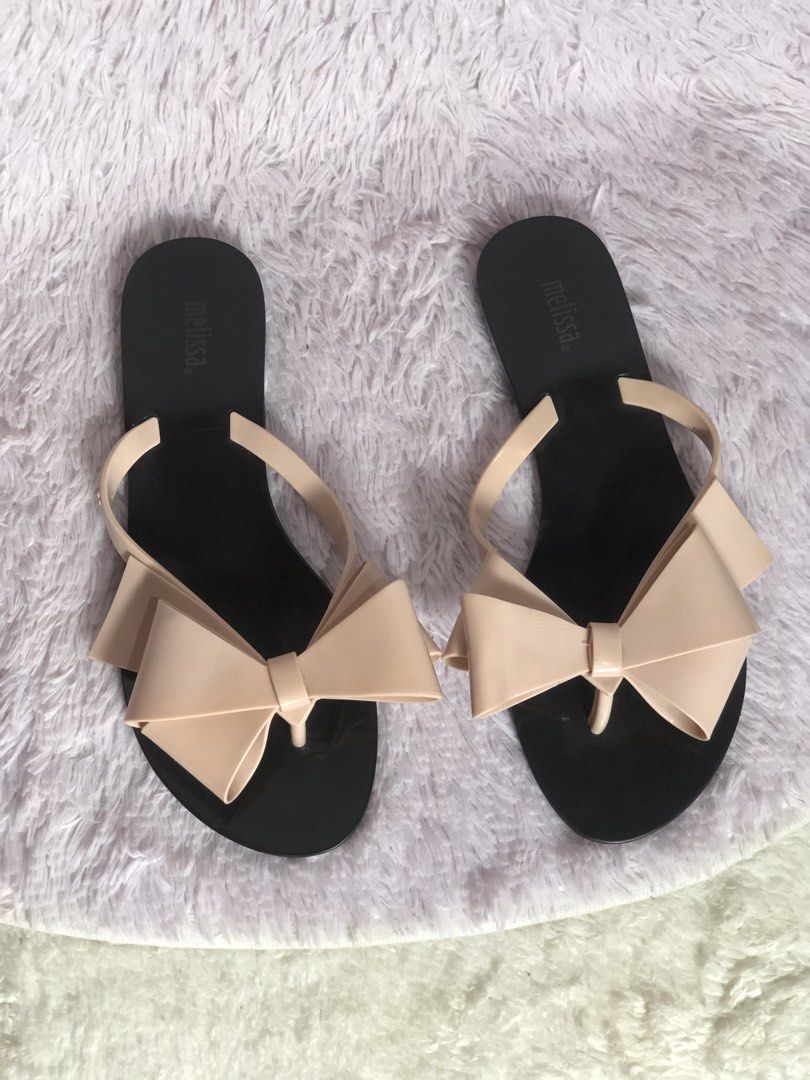 Melissa Flat Sandals Size 37 Bow Detail (Category: Flats & Sandals) located in Montevista. Submitted by rdthriftshub (Listing ID 1464656889, Image 3). Description: - Melissa flat sandals - Size: 37 - Features a cute bow detail on the strap - Soles show some signs of wear - Perfect for casual wear - Easy to slip on and off.