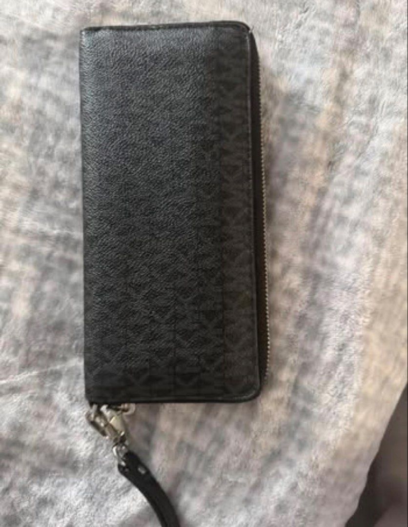 Michael Kors Black Monogram Print Zip-Around Wristlet Wallet (Category: Luxury Bags & Wallets) located in Manila. Submitted by kaia_studios (Listing ID 1464701399, Image 3). Description: - Brand: Michael Kors - Color: Classic Black with all-over MK monogram - Material: Textured leather with silver-tone hardware and brand plaque - Features: Detachable wrist strap and smooth zip-around closure - Interior: Multiple card slots, slip pockets, and a co