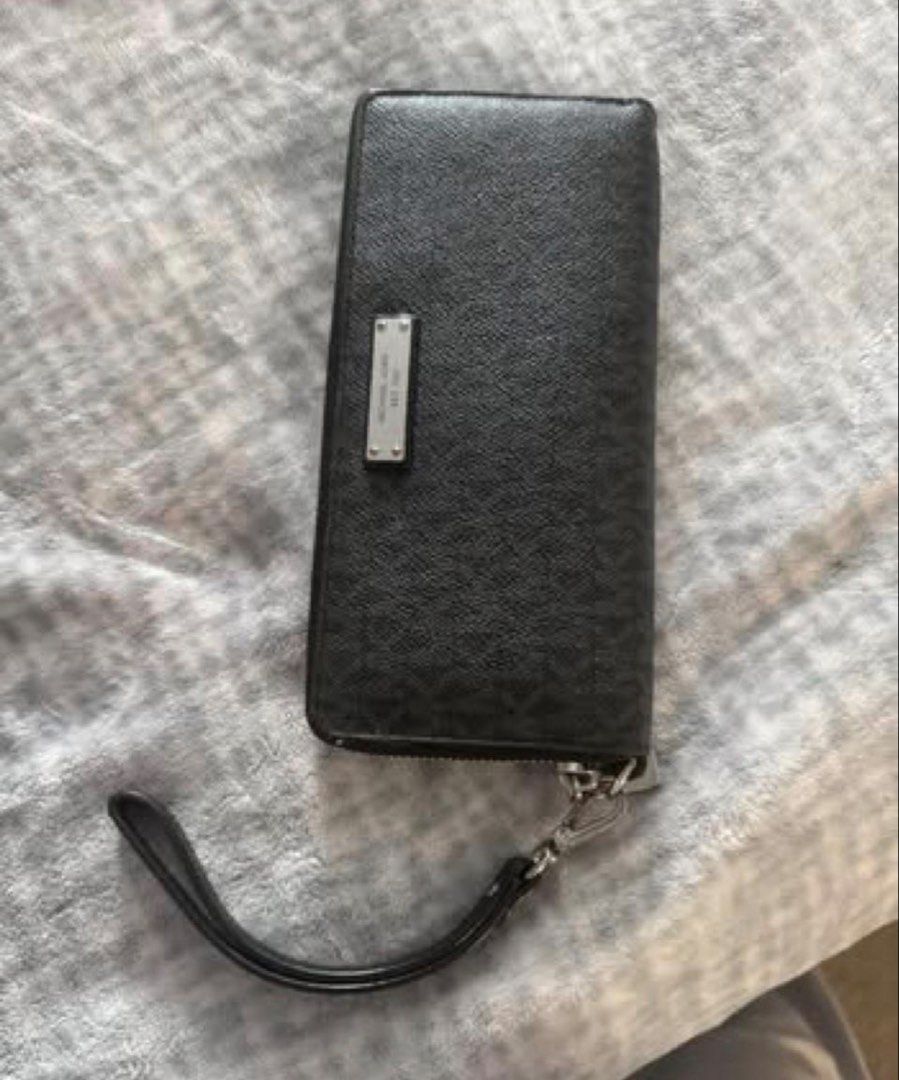 Michael Kors Black Monogram Print Zip-Around Wristlet Wallet (Category: Luxury Bags & Wallets) located in Manila. Submitted by kaia_studios (Listing ID 1464701399, Image 1). Description: - Brand: Michael Kors - Color: Classic Black with all-over MK monogram - Material: Textured leather with silver-tone hardware and brand plaque - Features: Detachable wrist strap and smooth zip-around closure - Interior: Multiple card slots, slip pockets, and a co