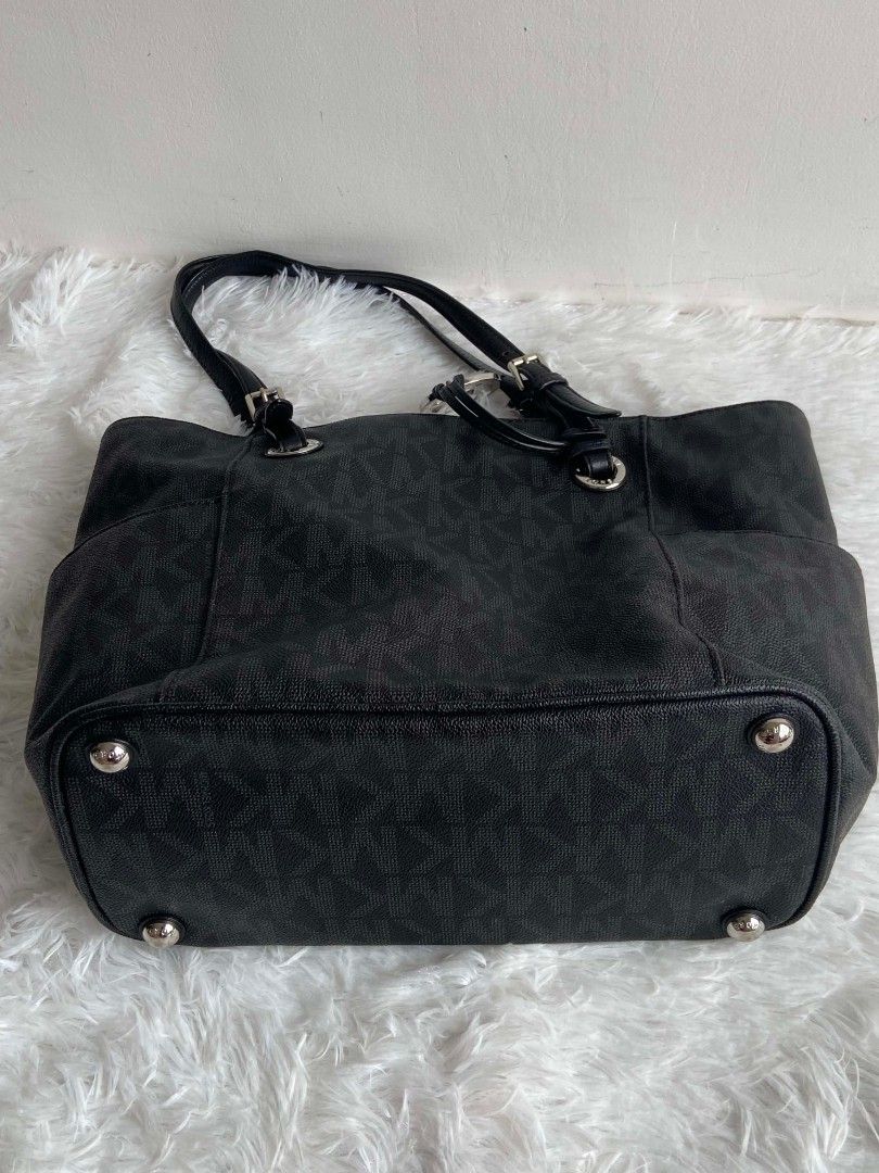 Michael Kors Black Monogram Tote Bag (Category: Tote Bags) located in Bulacan. Submitted by bella.ken.varietystore (Listing ID 1464663505, Image 2). Description: Black Michael Kors tote bag with MK monogram. Leather trim and handles. Silver hardware details. Has side pockets for easy access. Spacious interior. Great for everyday use or travel..