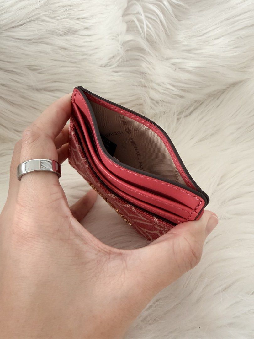 Michael Kors Card Holder Pink Monogram (Category: Luxury Bags & Wallets) located in Cainta. Submitted by mskath__ (Listing ID 1464593405, Image 2). Description: - Authentic Pink Michael Kors Card Holder - Features iconic MK monogram pattern - Multiple card slots for easy organization - Clear ID window on the back - Compact and stylish design - Perfect for keeping your essentials handy.
