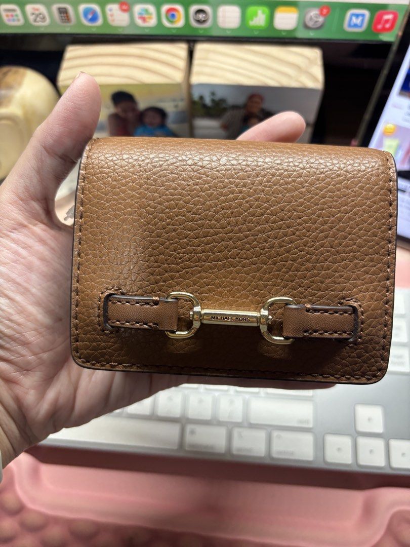 Michael Kors Carson Sm Flap Wallet (Category: Wallets & Card holders) located in San Juan City. Submitted by warmriver.74e50b (Listing ID 1464756133, Image 1). Description: - Brand: Michael Kors - Color: Luggage Brown - Material: Genuine pebbled leather - Retail Price: $178 (Original tag included) - Hardware: Gold-tone with MK lettering - Closure: Snap button - Interior: Card slots and zippered coin compartment - Condition: Brand new and 100% aut