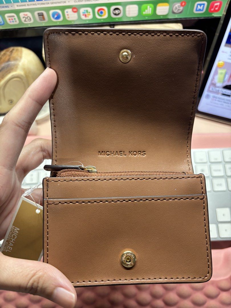 Michael Kors Carson Sm Flap Wallet (Category: Wallets & Card holders) located in San Juan City. Submitted by warmriver.74e50b (Listing ID 1464756133, Image 3). Description: - Brand: Michael Kors - Color: Luggage Brown - Material: Genuine pebbled leather - Retail Price: $178 (Original tag included) - Hardware: Gold-tone with MK lettering - Closure: Snap button - Interior: Card slots and zippered coin compartment - Condition: Brand new and 100% aut